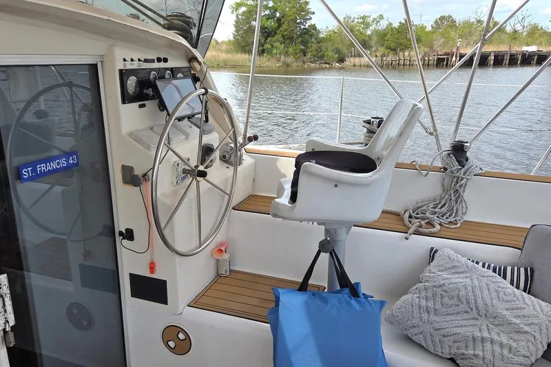 Slide: The Image of Cockpit of 1995 Catamaran St. Francis 43 with steering wheel and captain's chair. - 18