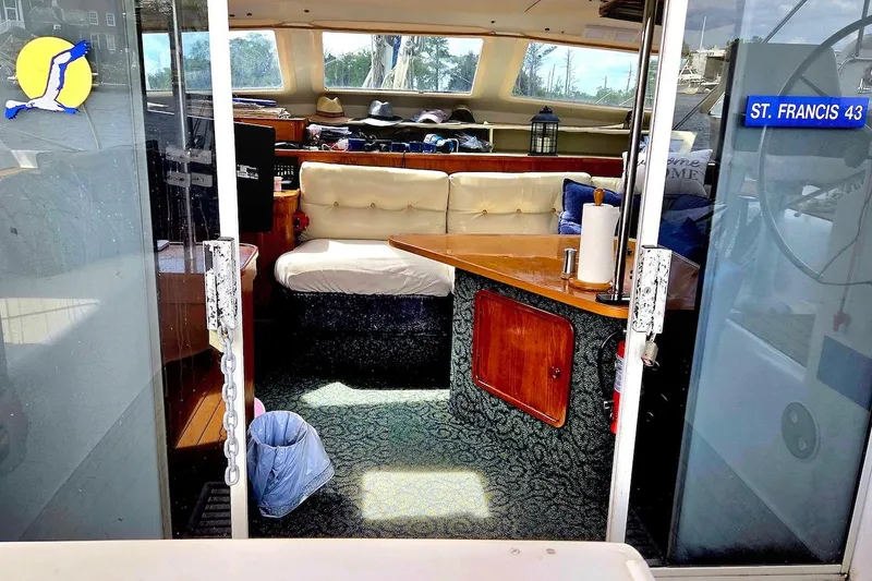 Slide: The Image of Interior view of 1995 Catamaran St. Francis 43, featuring cozy seating and wooden table. - 21
