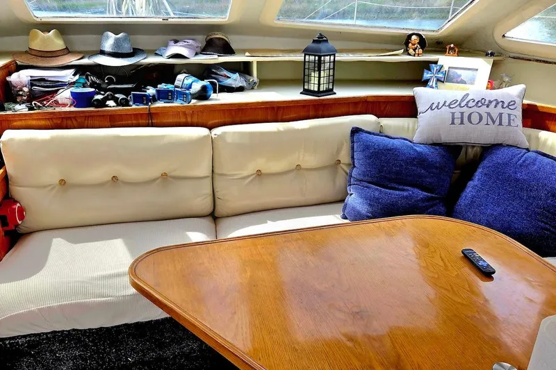 Slide: The Image of Cozy interior of 1995 Catamaran St. Francis 43 with cushions, hats, and decor. - 23