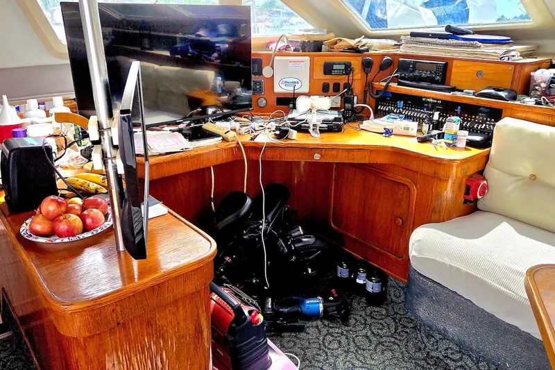 Slide: The Image of Interior of 1995 Catamaran St. Francis 43 with electronics and fruit on wooden desk. - 24