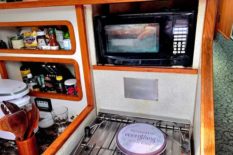 Slide: The Image of Galley kitchen in 1995 Catamaran St. Francis 43 with microwave and spices. - 26