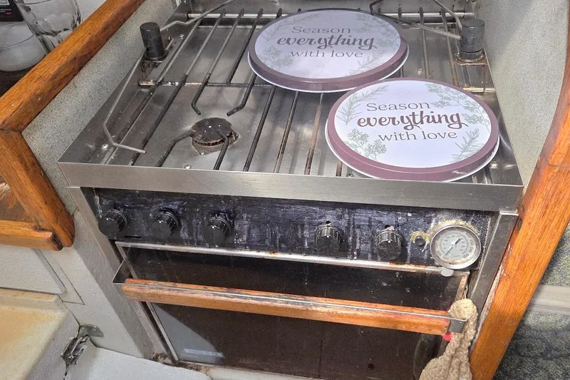 Slide: The Image of Stainless steel stove in 1995 Catamaran St. Francis 43, featuring decorative plates with love-themed text. - 27