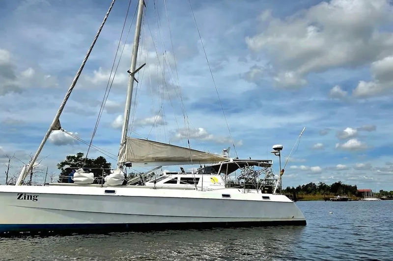 Slide: The Image of Catamaran St. Francis 43 sailing on a calm lake under a partly cloudy sky. - 3