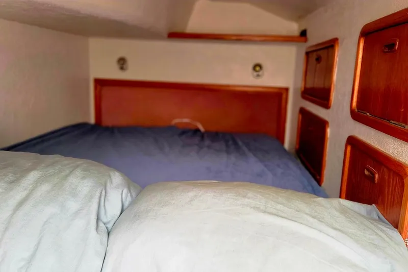 Slide: The Image of Cozy cabin interior of 1995 Catamaran St. Francis 43 with wooden storage compartments. - 32