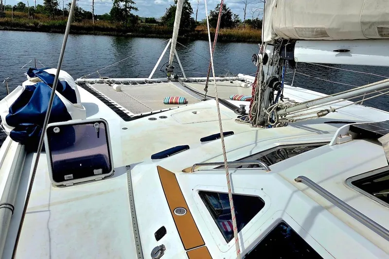 Slide: The Image of 1995 Catamaran St. Francis 43 deck view with sails and rigging on calm water. - 7