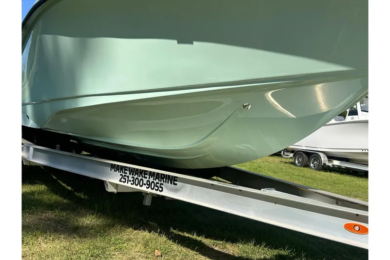 Slide: The Image of 2026 Action Craft 22 Bay boat on trailer, Make Wake Marine contact visible. - 12