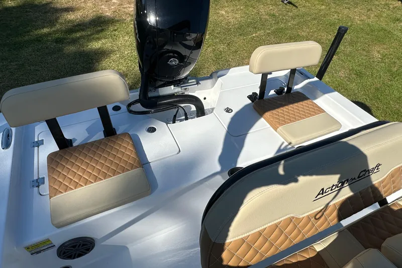 Slide: The Image of 2026 Action Craft 22 Bay boat interior with tan quilted seats and motor. - 14