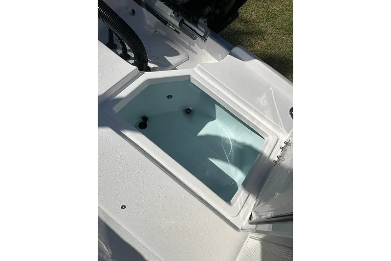 Slide: The Image of Livewell compartment on a 2026 Action Craft 22 Bay boat, open and empty. - 15