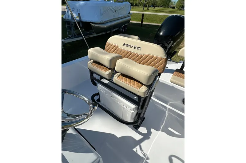 Slide: The Image of 2026 Action Craft 22 Bay boat with tan quilted seats and steering wheel. - 17