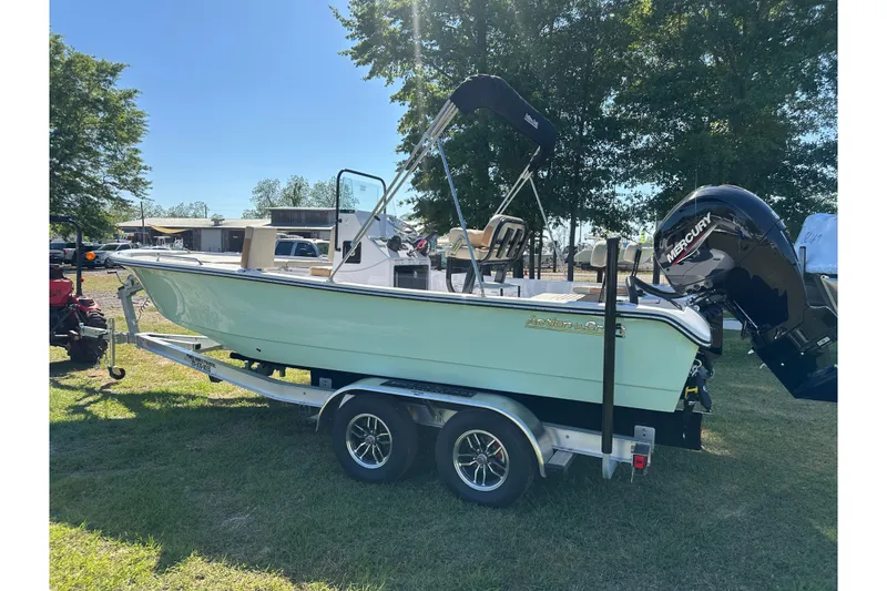 Slide: The Image of 2026 Action Craft 22 Bay boat on trailer, featuring a Mercury outboard motor. - 2