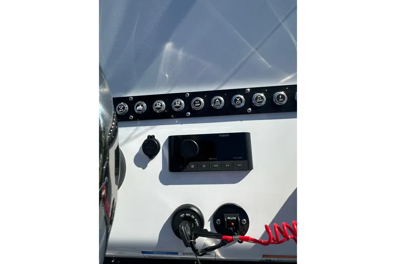 Slide: The Image of Dashboard of 2026 Action Craft 22 Bay boat with control panel and switches. - 22