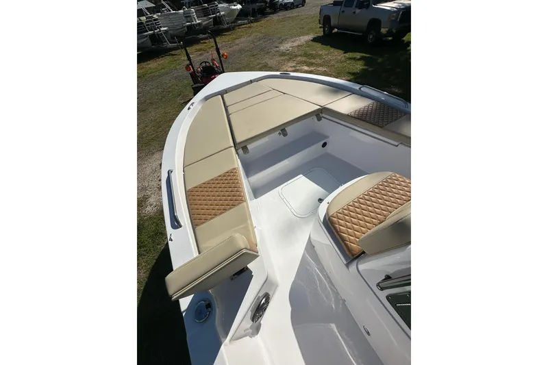 Slide: The Image of 2026 Action Craft 22 Bay boat with tan cushioned seating and sleek design. - 26