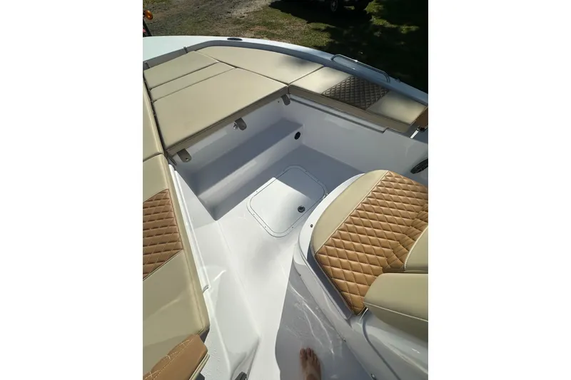 Slide: The Image of 2026 Action Craft 22 Bay boat interior with tan cushioned seating. - 27