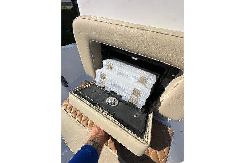 Slide: The Image of Storage compartment on 2026 Action Craft 22 Bay boat with tackle boxes inside. - 29