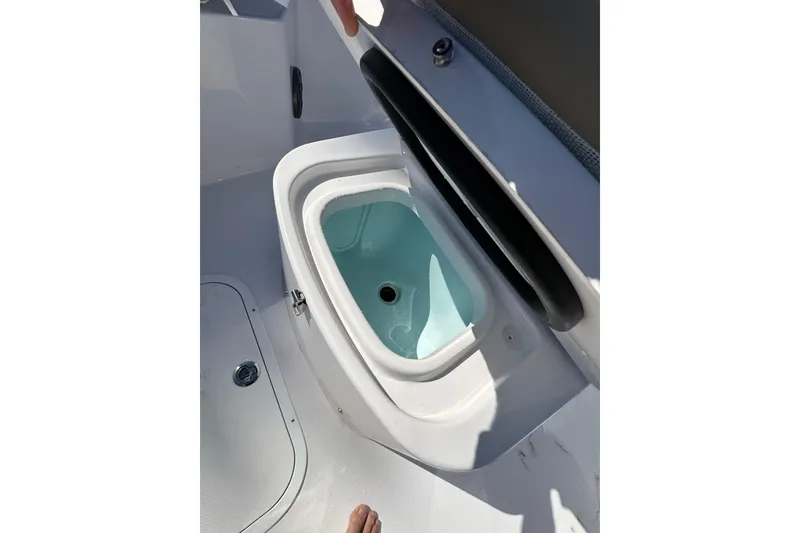 Slide: The Image of Open storage compartment on 2026 Action Craft 22 Bay boat deck. - 30