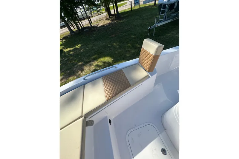 Slide: The Image of 2026 Action Craft 22 Bay boat with tan quilted seating, parked on grass. - 31