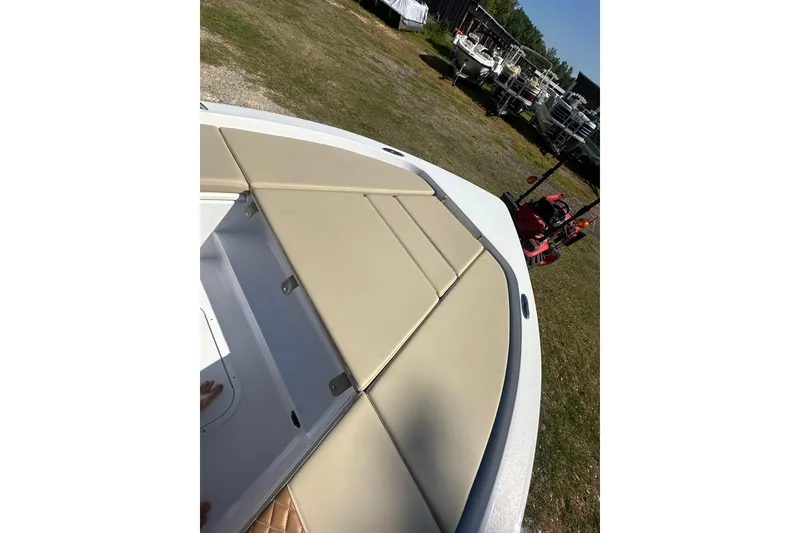 Slide: The Image of 2026 Action Craft 22 Bay boat with beige seating, parked outdoors. - 33