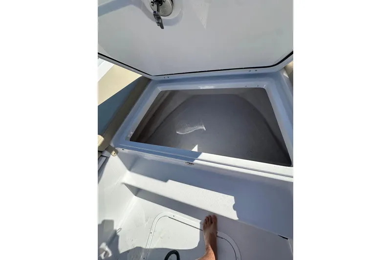 Slide: The Image of Open storage compartment on 2026 Action Craft 22 Bay boat, showcasing interior space. - 34