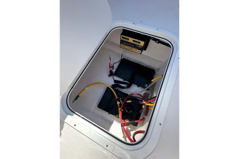 Slide: The Image of Battery compartment of 2026 Action Craft 22 Bay boat with wiring and charger. - 39