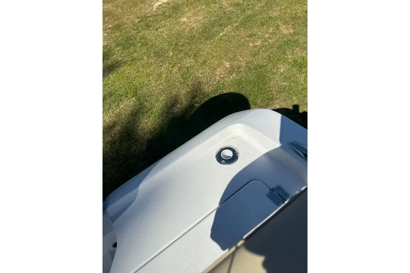 Slide: The Image of 2026 Action Craft 22 Bay boat detail on grassy background. - 43