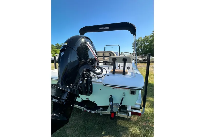 Slide: The Image of 2026 Action Craft 22 Bay boat with Mercury outboard motor, displayed outdoors. - 5