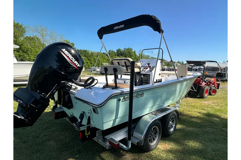 Slide: The Image of 2026 Action Craft 22 Bay boat with Mercury engine on trailer, parked outdoors. - 7