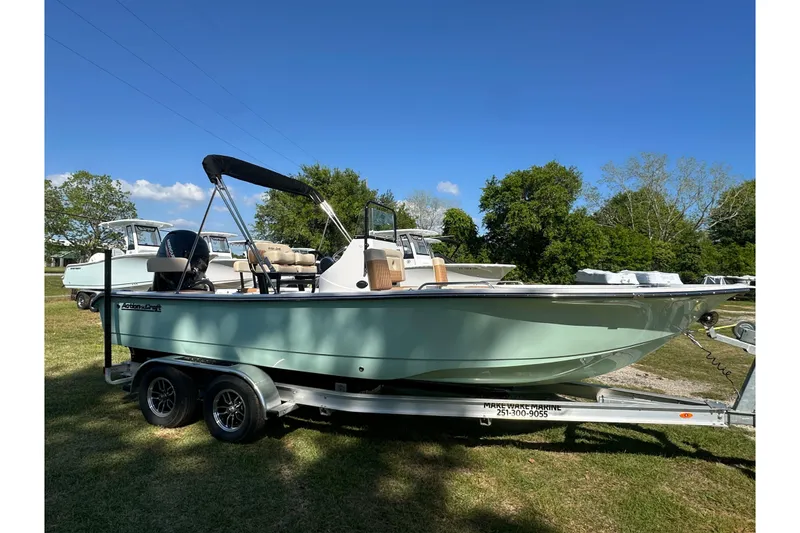 Slide: The Image of 2026 Action Craft 22 Bay boat on trailer, parked on grass under clear blue sky. - 9