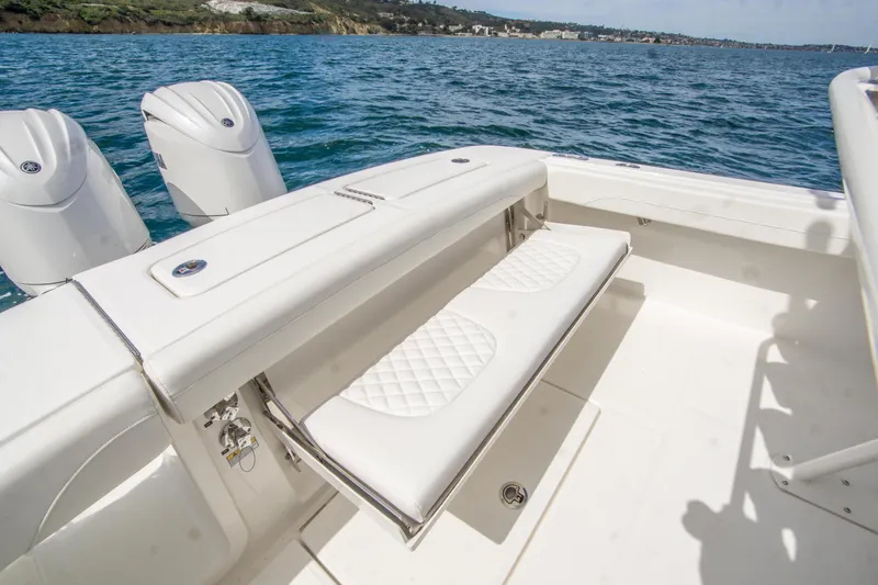 Slide: The Image of 2026 Regulator 23 boat with white seating and dual engines on open water. - 8