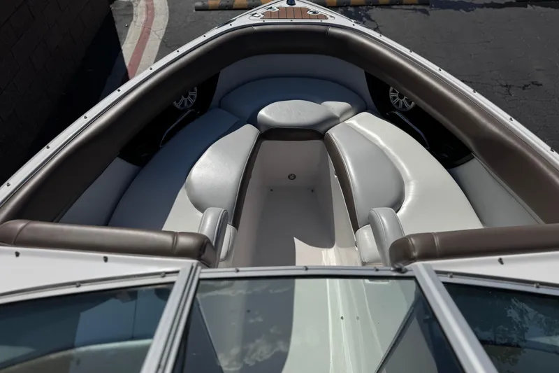 Slide: The Image of 2010 Regal 2300 RX Bowrider interior with white and brown seating, showcasing spacious design. - 16