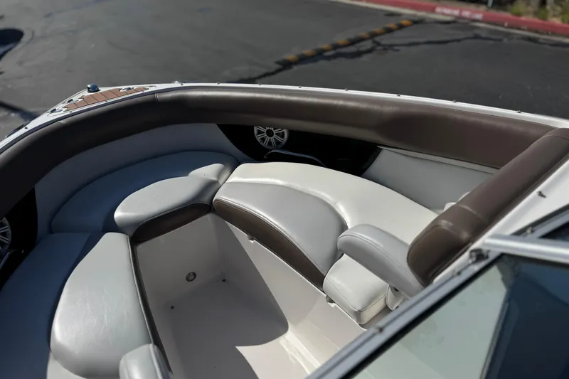 Slide: The Image of 2010 Regal 2300 RX Bowrider boat interior with cushioned seating and speaker system. - 18