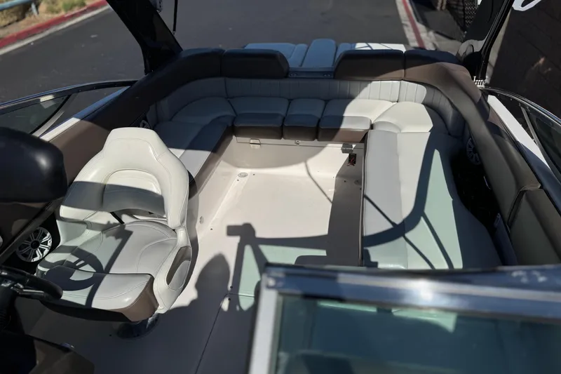 Slide: The Image of Interior view of 2010 Regal 2300 RX Bowrider boat with seating and steering wheel. - 22