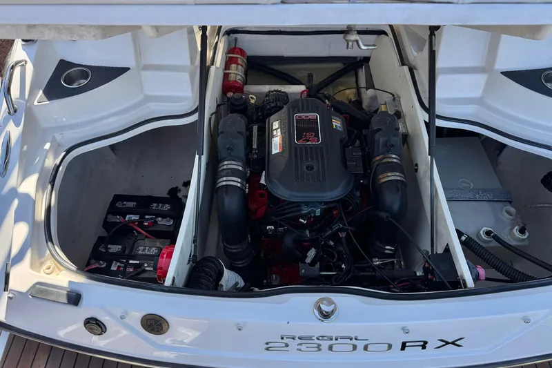 Slide: The Image of Engine compartment of a 2010 Regal 2300 RX Bowrider, showcasing the engine and battery setup. - 24