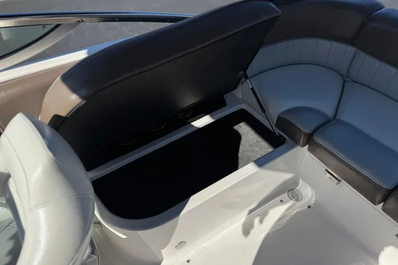 Slide: The Image of 2010 Regal 2300 RX Bowrider interior with open storage compartment and cushioned seating. - 26