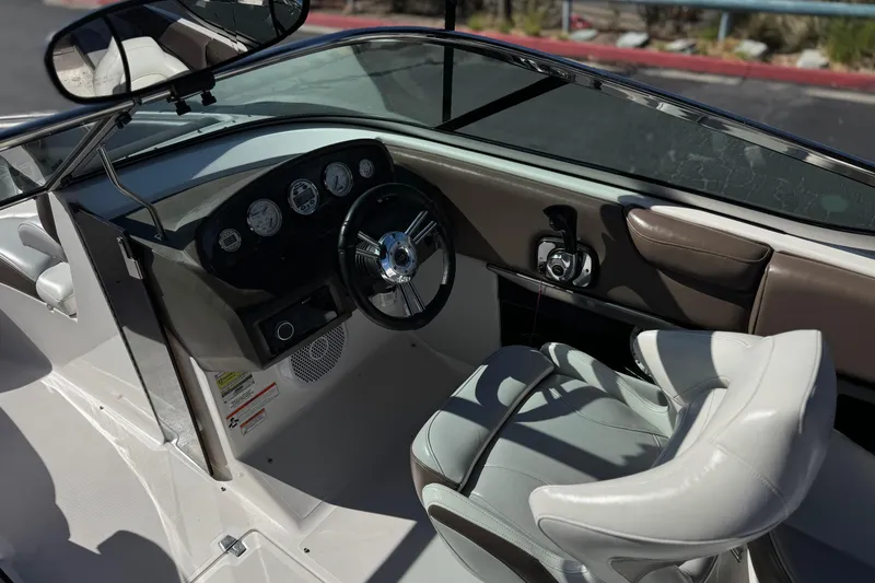 Slide: The Image of 2010 Regal 2300 RX Bowrider cockpit with steering wheel and dashboard controls. - 31