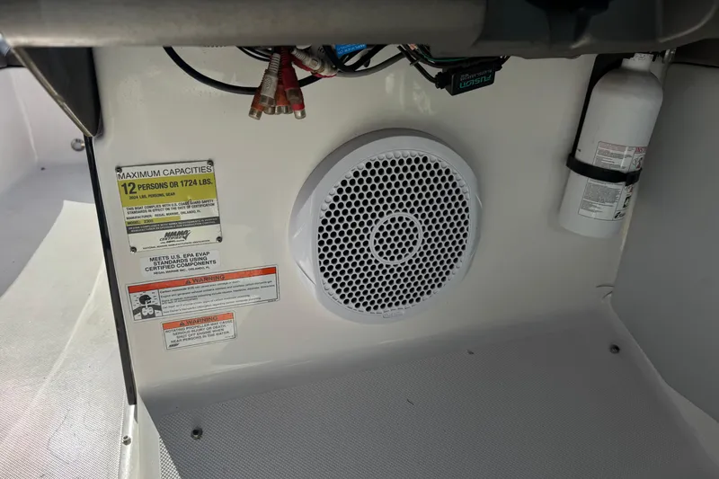 Slide: The Image of Interior of 2010 Regal 2300 RX Bowrider showing speaker, capacity label, and fire extinguisher. - 34