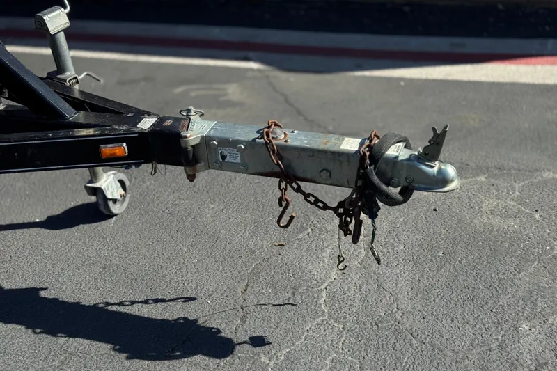 Slide: The Image of Trailer hitch of a 2010 Regal 2300 RX Bowrider on pavement, secured with chains. - 36