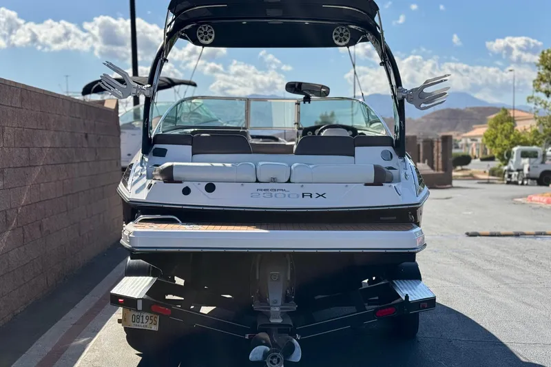 Slide: The Image of 2010 Regal 2300 RX Bowrider boat parked on a sunny day. - 4