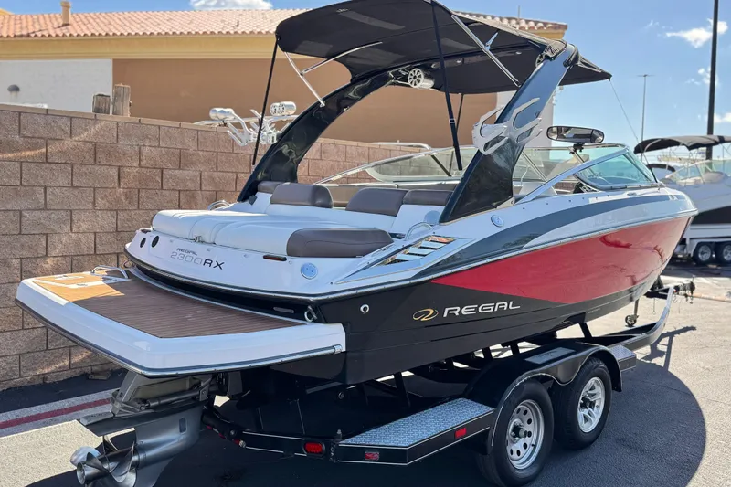 Slide: The Image of 2010 Regal 2300 RX Bowrider boat on trailer, featuring sleek design and vibrant colors. - 5