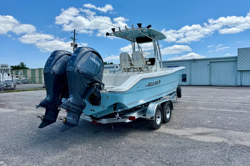 Slide: The Image of 2026 Bulls Bay 255 Center Console boat with dual Yamaha engines on a trailer. - 4
