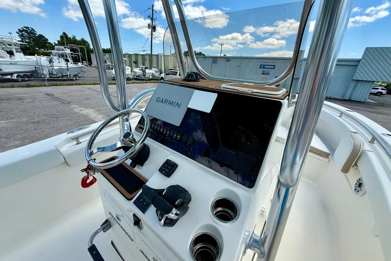 Slide: The Image of 2026 Bulls Bay 255 Center Console boat with Garmin navigation system, docked outdoors. - 8