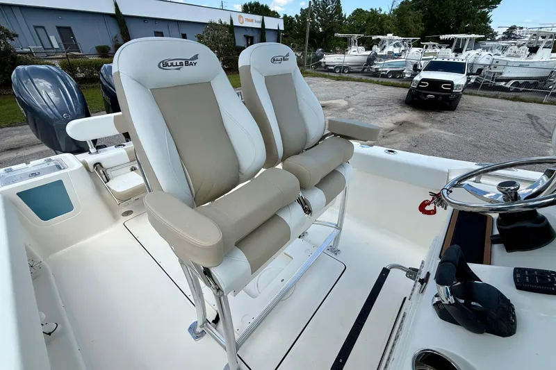 Slide: The Image of 2026 Bulls Bay 255 Center Console boat with dual seats and steering wheel. - 9