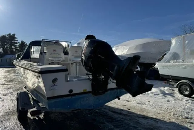Slide: The Image of 1991 Mako 191 Inshore boat with outboard motor on trailer in snowy setting. - 5