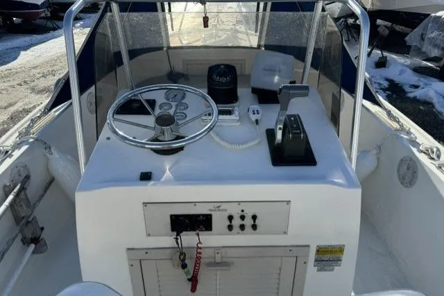 Slide: The Image of 1991 Mako 191 Inshore boat console with steering wheel and controls. - 6