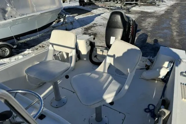 Slide: The Image of 1991 Mako 191 Inshore boat interior with two swivel seats and outboard motor. - 7