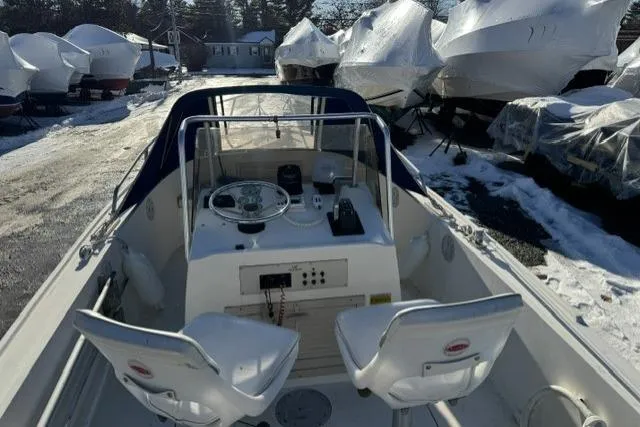 Slide: The Image of 1991 Mako 191 Inshore boat with dual seats, parked in snowy marina. - 9