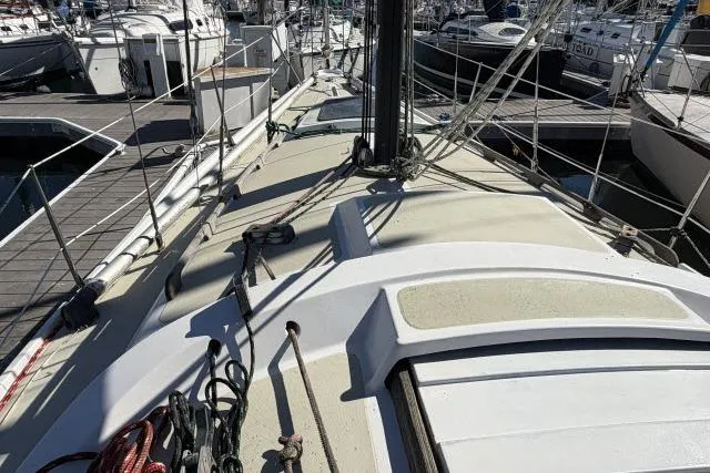 Slide: The Image of 1976 CAL 3-30 sailboat deck with rigging, docked at marina. - 13