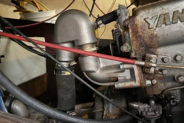 Slide: The Image of Close-up of a 1976 CAL 3-30 engine component with visible pipes and connections. - 15