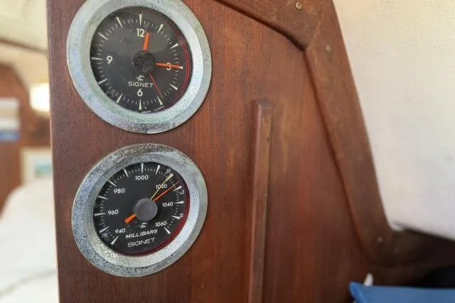 Slide: The Image of Vintage CAL 3-30 boat gauges from 1976, featuring a clock and barometer on wooden panel. - 5