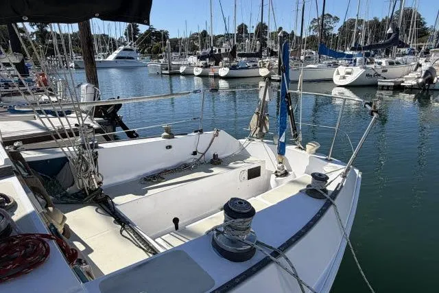 Slide: The Image of 1976 CAL 3-30 sailboat docked in a marina with other boats. - 7