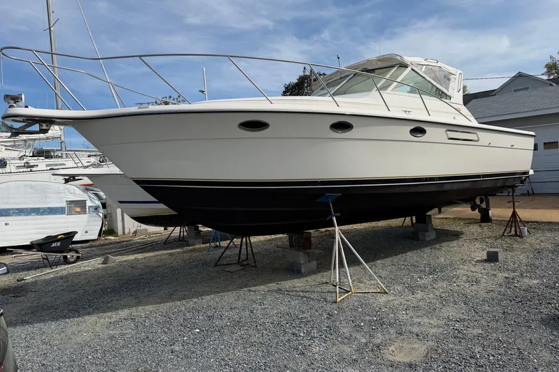 The Image of 1994 Tiara Yachts 3100 Open boat on stands in a marina setting. - 0